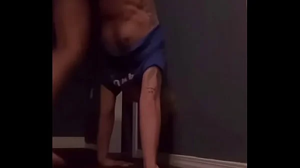 Teen doing a handstand with nip slip